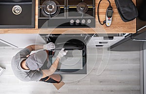 Professional Appliances Installer and Testing New Kitchen Stove