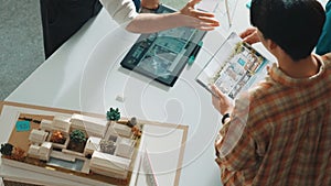 Professional architect sit while explain house plan to manager. Alimentation.