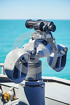 Professional army binoculars on a military ship deck