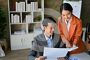 Professional Asian businessman working with a gorgeous female financial manager