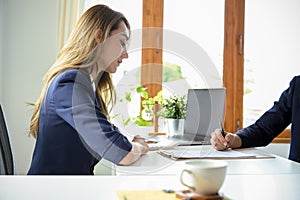 Professional Asian businesswoman meeting with her partner to sign the business deal