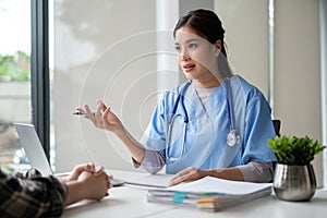 A professional Asian female doctor is having a medical consultation with a patient