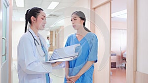 Professional, Asian young female medical doctor, staff in uniform standing in hospital corridor.