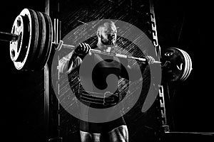 Professional athlete prepares to squat with a barbell