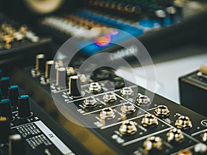 Professional audio equipment with faders knobs and buttons