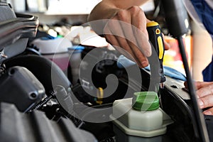 Professional auto mechanic fixing car in service center, closeup