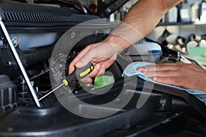 Professional auto mechanic fixing car in service center, closeup