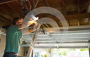 Professional automatic garage door opener repair service technician man working