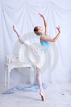 Professional ballet dancer posing on white