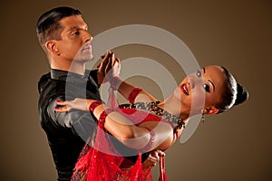 Professional ballroom dance couple preform an exhibition dance photo