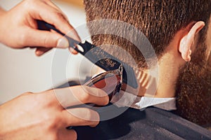 Professional barber cutting hair of his client