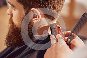 Professional barber cutting hair of his client