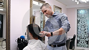 The professional barber discusses with the client how the cutter should be executed. Concept of reopening small and