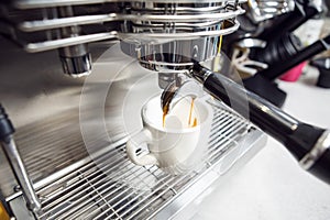 Professional Barista Crafting Strong and Dense Espresso in Modern Coffee Machine