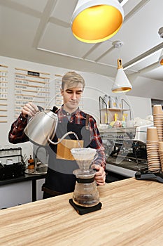 Professional barista man making coffee using filter