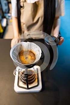 Professional barista preparing a caffeinated beverage for a customer
