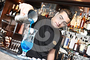 Professional bartender making cocktail in bar