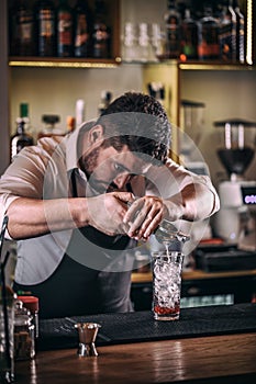 Professional bartender making cocktail