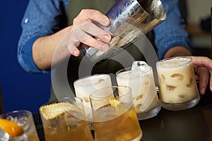 Professional Bartender is making fresh cocktail at bar counter