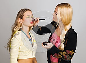 Professional beautician applying makeup