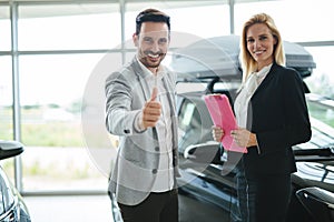 Professional saleswoman working in car dealership