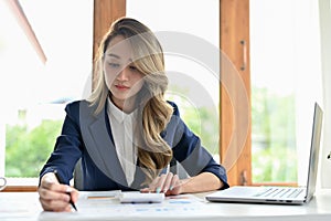 Professional Asian businesswoman concentrated working on her business task in the office