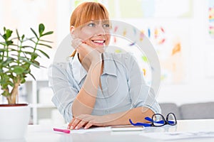 Professional beautiful young woman sitting her desk at her home