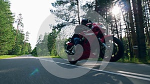 Professional biker does stunts on a red motocycle.