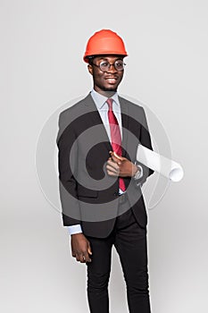 Professional black architect visiting construction site with blueprint plans and protective safety hard hat isolated on white