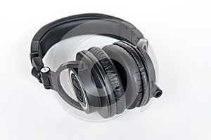 Professional black wired headphones Audio-Technica with gold plug on white background