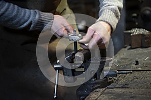 Professional blacksmith working with metal