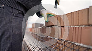 Professional bricklaying during the construction of a house. The construction of walls made of expensive red bricks