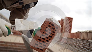 Professional bricklaying during the construction of a house. The construction of walls made of expensive red bricks