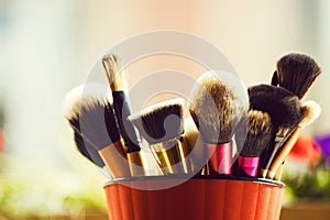 Professional brush for fashionable makeup or cosmetic in pink cup