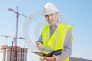 Professional builder standing with a notebook