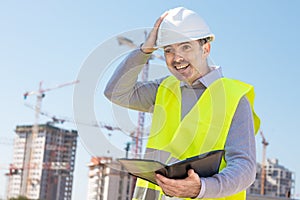 Professional builder standing with a notebook