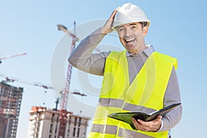 Professional builder standing with a notebook
