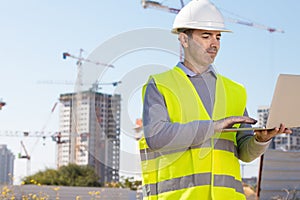 Professional builder standing with a notebook