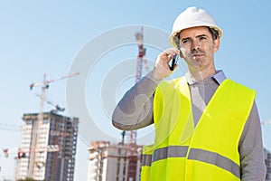 Professional builder standing talking on a phone