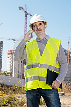 Professional builder standing talking on a phone