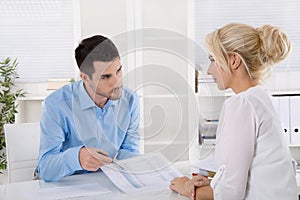 Professional business meeting: customer and advicer analyzing financial situation.