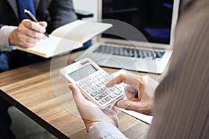 Professional business people working with calculator, Doing finance on laptop, document graph and analysis business strategy to d