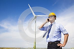 Professional business standing with wind generator