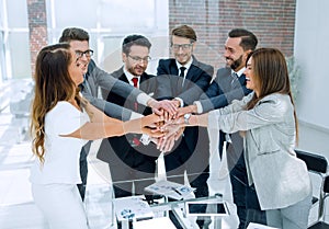 Professional business team making tower out of their hands