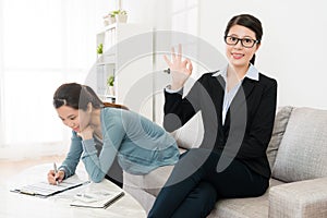 Professional business woman showing okay gesture