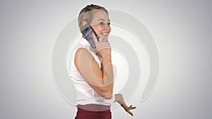 Professional business woman smiling with mobile phone talking on gradient background.