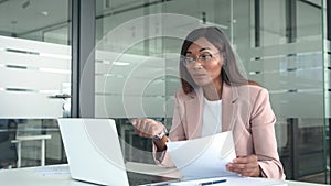 Professional business woman team leader having hybrid meeting in office.