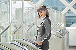 Professional business woman walking through platform barrier