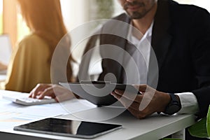 Professional businessman analyzing investment data documents, checking reports on white office desk