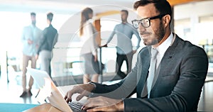 Professional businessman working on laptop in office